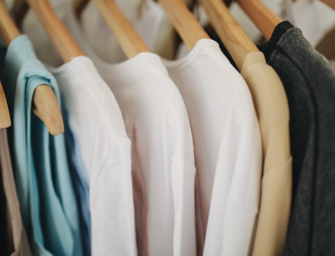 White Organic Cotton Shirts on Wooden Hangers – Sustainable Fashion Display